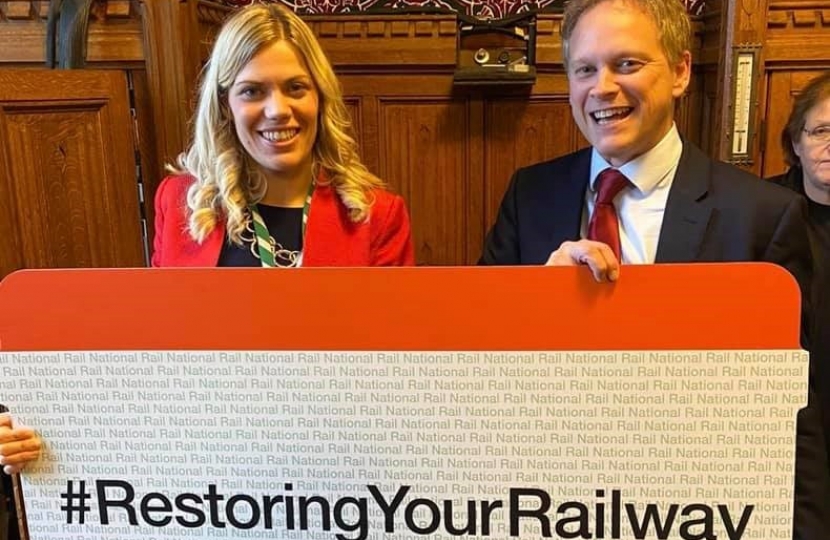 Miriam Cates MP with Grant Shapps holding a giant railway ticket