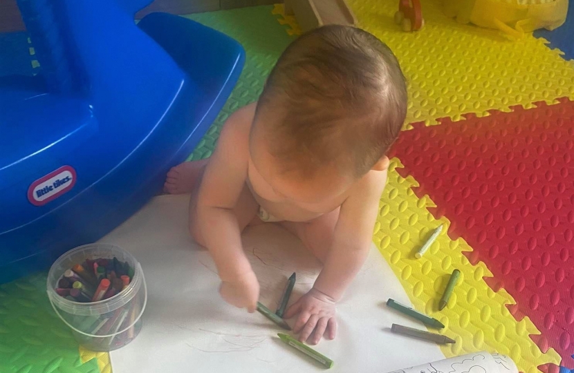 Baby painting representing early years investment